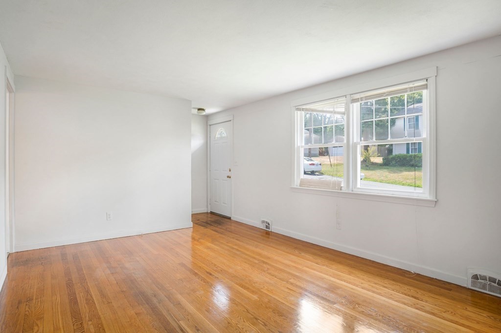 23 Plumtree Circle Springfield, MA 01118 - Photo 4 of 29 an empty room with wooden floor and windows