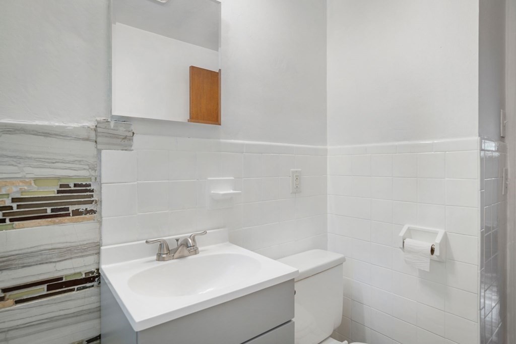 23 Plumtree Circle Springfield, MA 01118 - Photo 8 of 29 a bathroom with a sink a toilet and a mirror