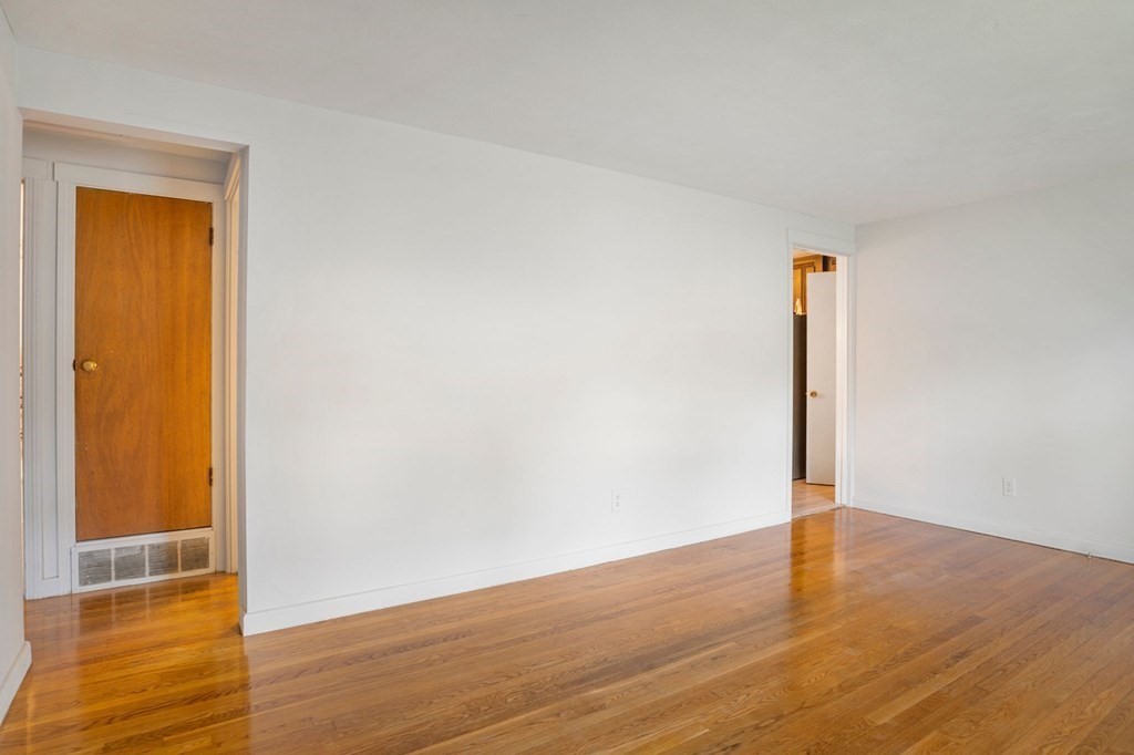 23 Plumtree Circle Springfield, MA 01118 - Photo 9 of 29 a view of an empty room with wooden floor and a window