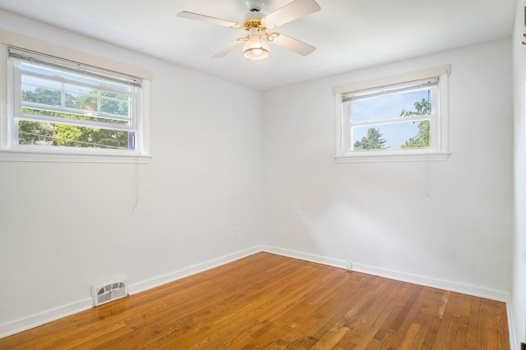 23 Plumtree Circle Springfield, MA 01118 - Photo 10 of 29 a view of an empty room with a window and a ceiling fan