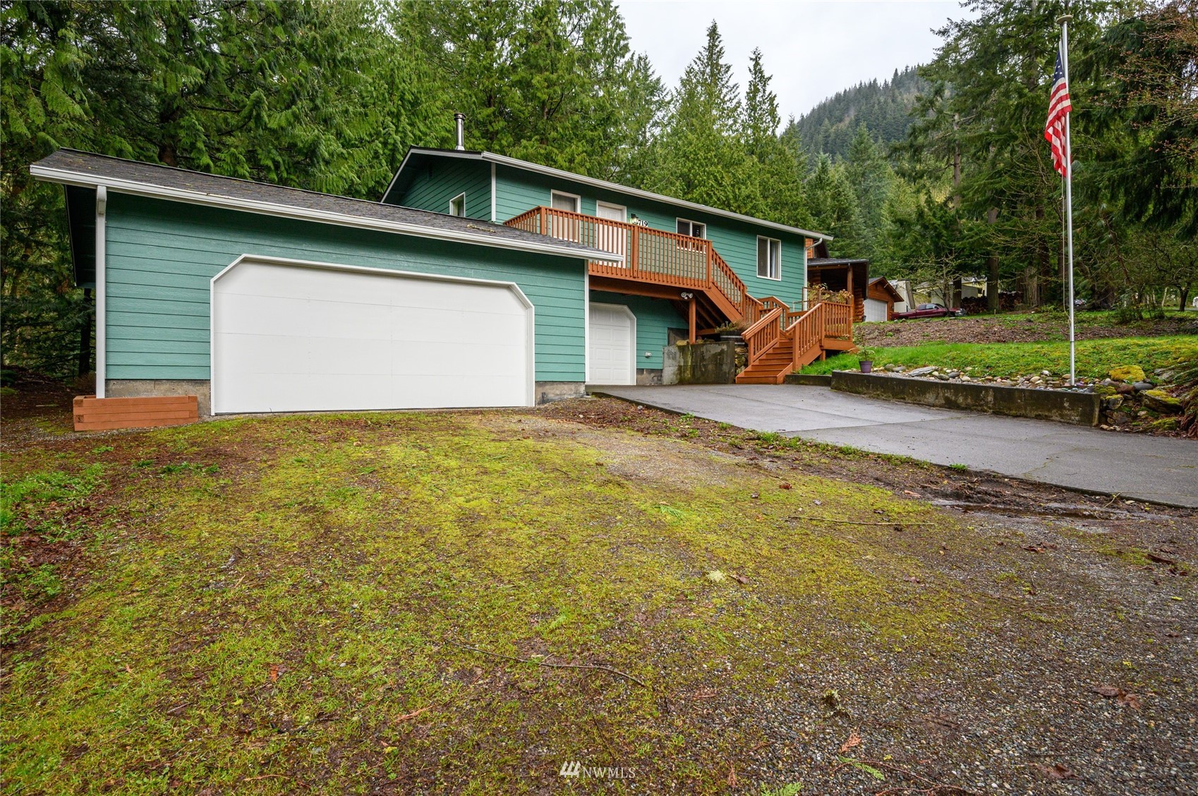 719 W Road Sedro-Woolley, WA 98284 - Photo 1 of 22 a front view of a house with a yard and garage