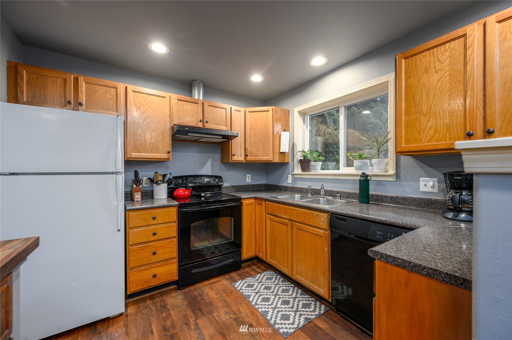 719 W Road Sedro-Woolley, WA 98284 - Photo 6 of 22 a kitchen with stainless steel appliances granite countertop a sink stove and refrigerator