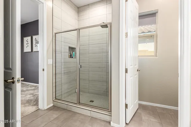 a bathroom with a glass shower door