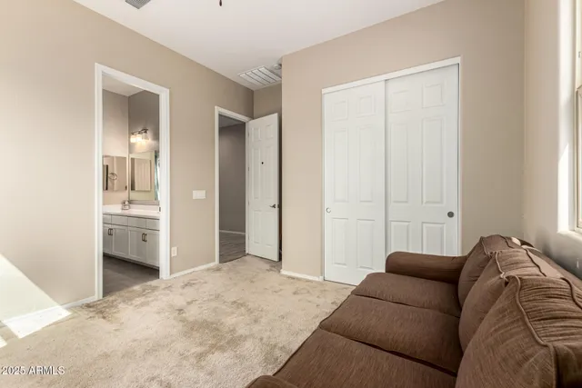 a living room with a couch and dresser