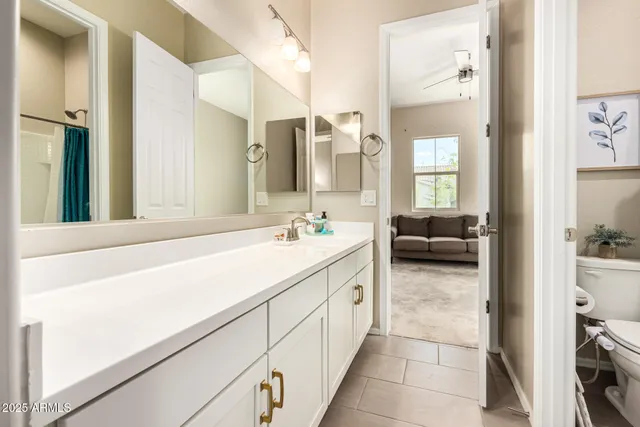 a spacious bathroom with a shower sink and mirror