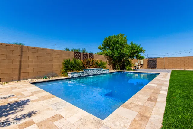 a view of a swimming pool with a lounge chairs