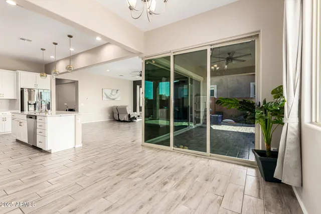 a view of a kitchen with furniture and a potted plant