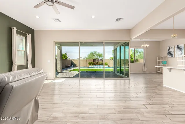 a living room with furniture and a floor to ceiling window