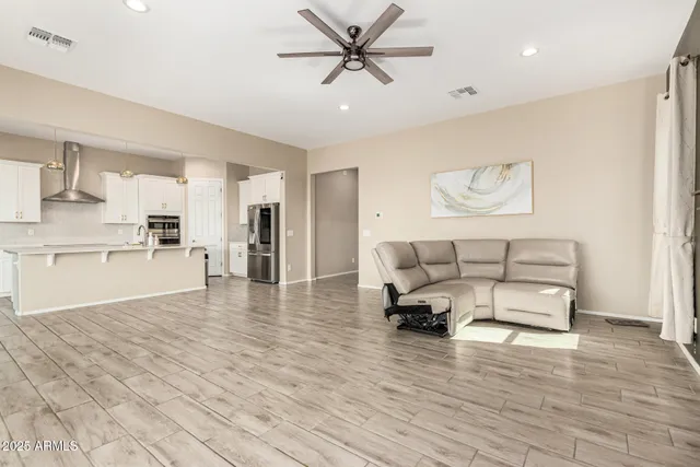 a living room with furniture and kitchen view