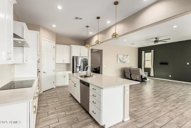 a large white kitchen with a stove and refrigerator