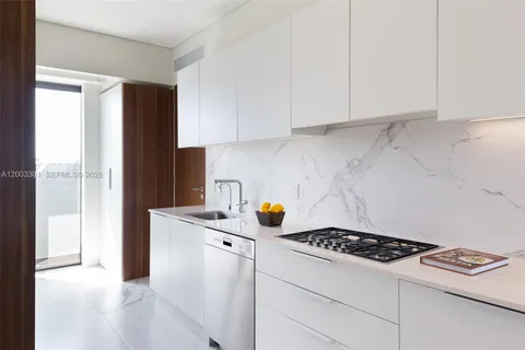 a kitchen with a refrigerator and a stove