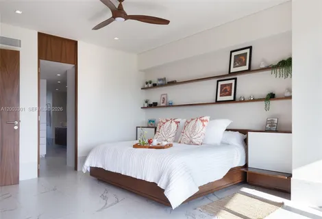 a bedroom with a large bed and a large window