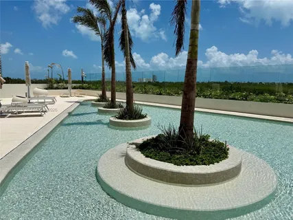 a view of a swimming pool and lounge chair