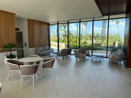 a view of a terrace with furniture and a garden