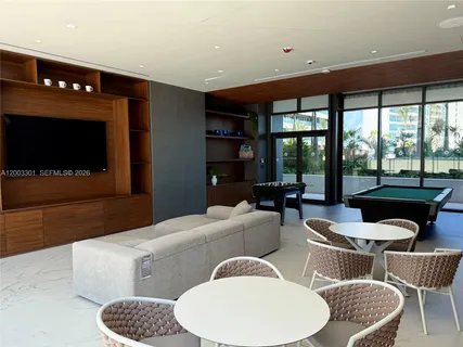 a living room with furniture a rug and a table