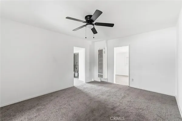 a view of empty room with ceiling fan