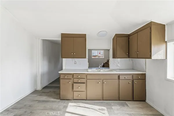 a room with a sink and cabinets