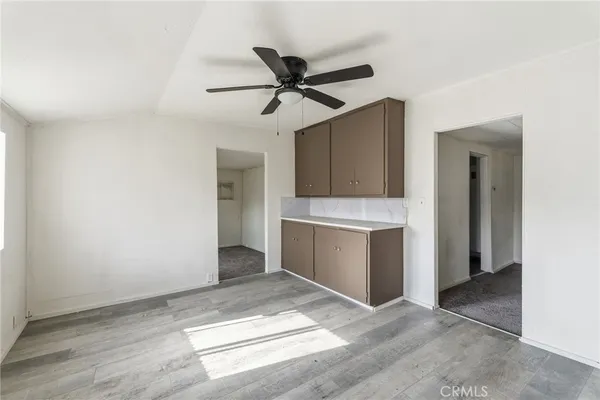 a view of a kitchen with a sink and a refrigerator