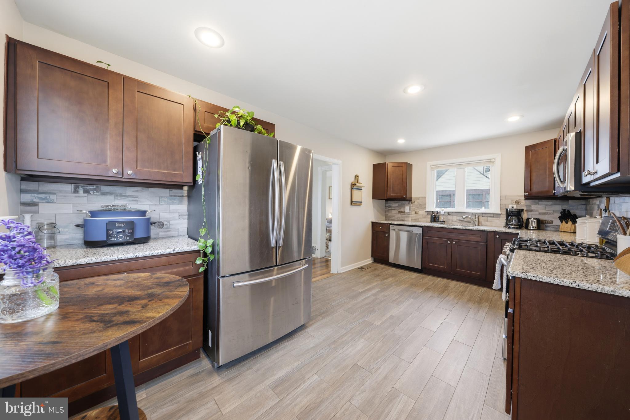 212 Grape Street Hammonton, NJ 08037 - Photo 16 of 36 a kitchen with stainless steel appliances granite countertop a refrigerator stove microwave and sink