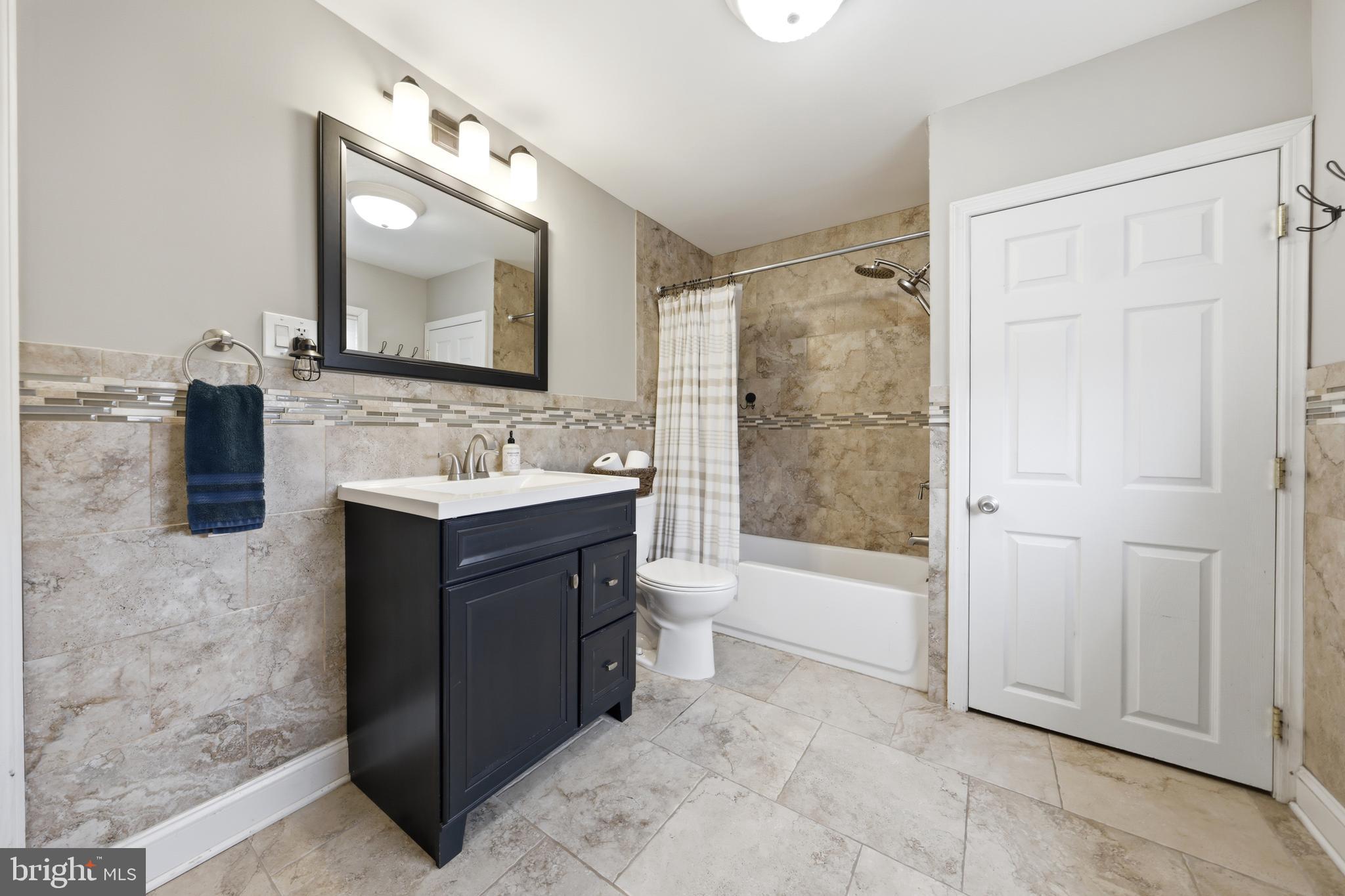 212 Grape Street Hammonton, NJ 08037 - Photo 29 of 36 a bathroom with a bathtub shower sink and mirror