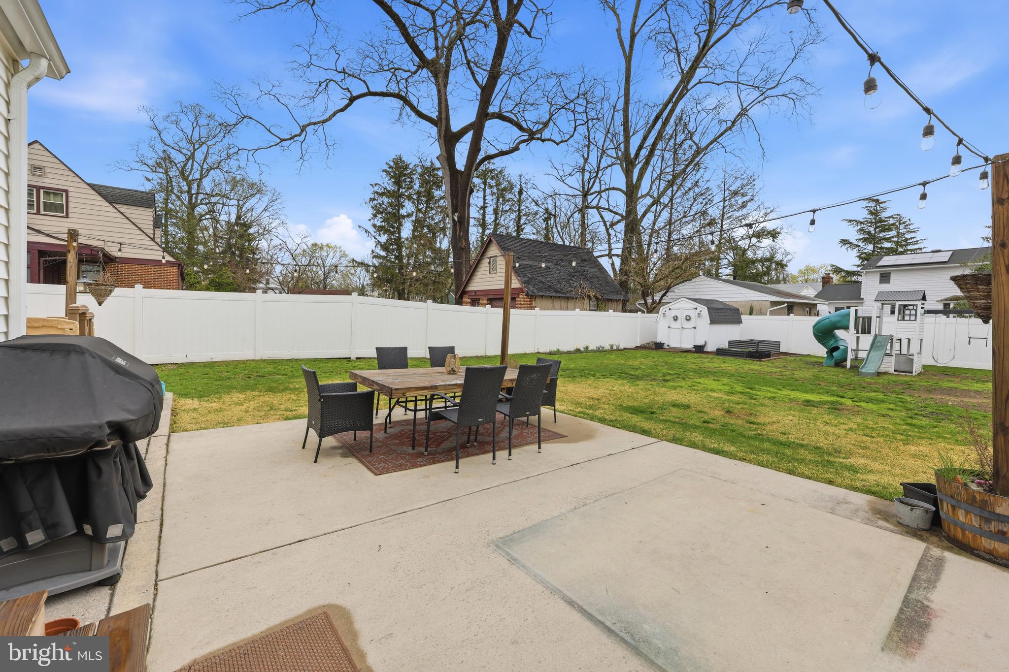 212 Grape Street Hammonton, NJ 08037 - Photo 35 of 36 a view of a patio with table and chairs with wooden fence and plants