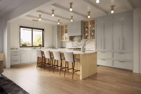 a large kitchen with cabinets chairs and wooden floor