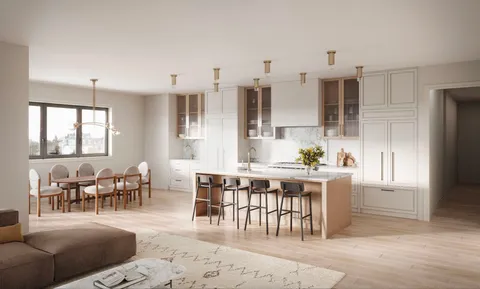 a living room with lots of furniture and kitchen view