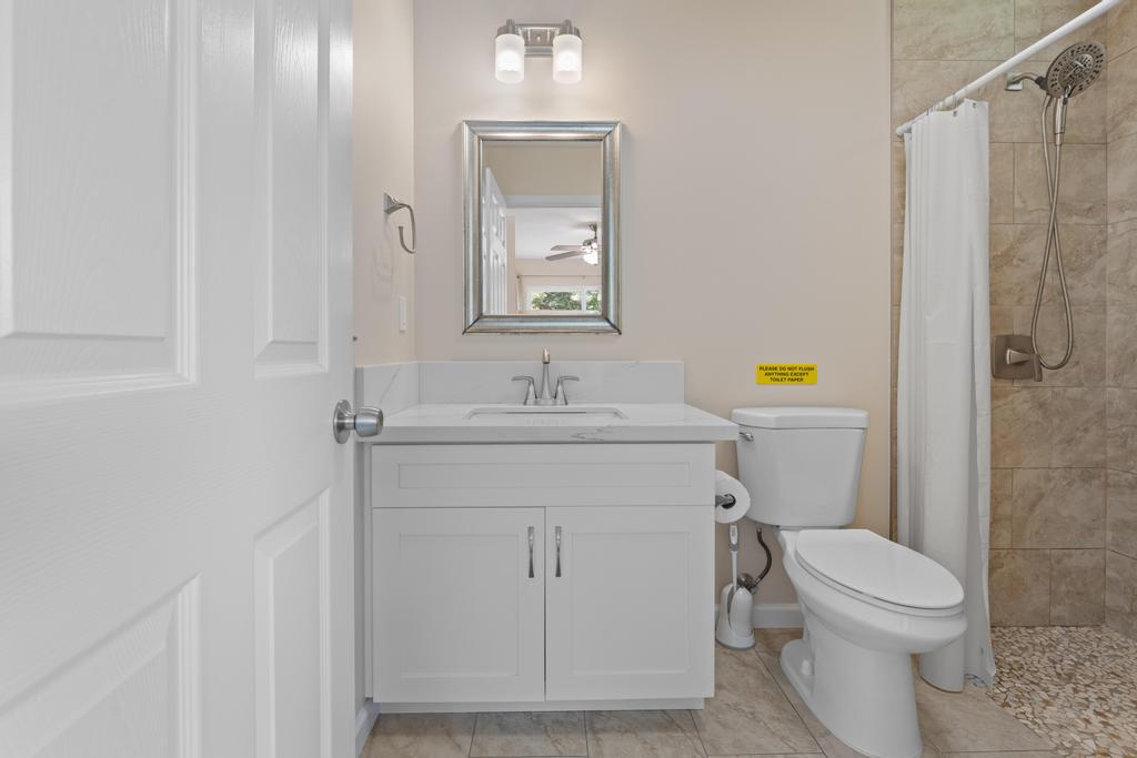 15-1622 12th Avenue Keaau, HI 96749 - Photo 12 of 30 a bathroom with a sink a toilet and shower