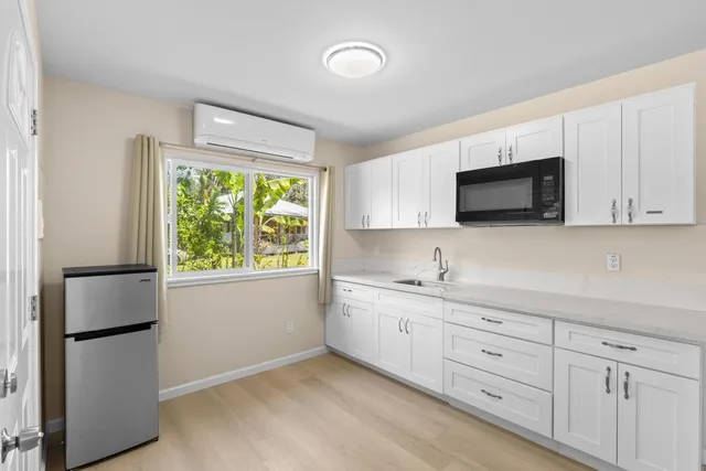 a bedroom with a bed mirror and a window