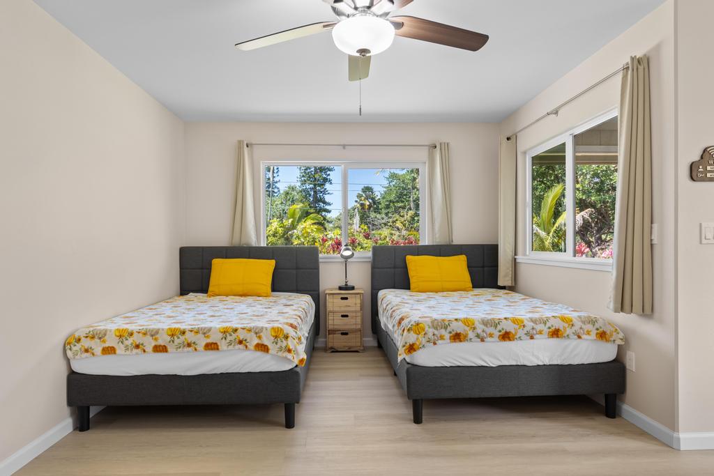 15-1622 12th Avenue Keaau, HI 96749 - Photo 21 of 30 a bedroom with a bed mirror and a window