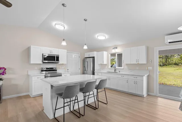 a kitchen with a sink a table and chairs