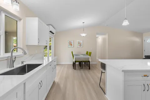 a bedroom with a bed chandelier and window
