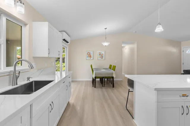 a bedroom with a bed chandelier and window