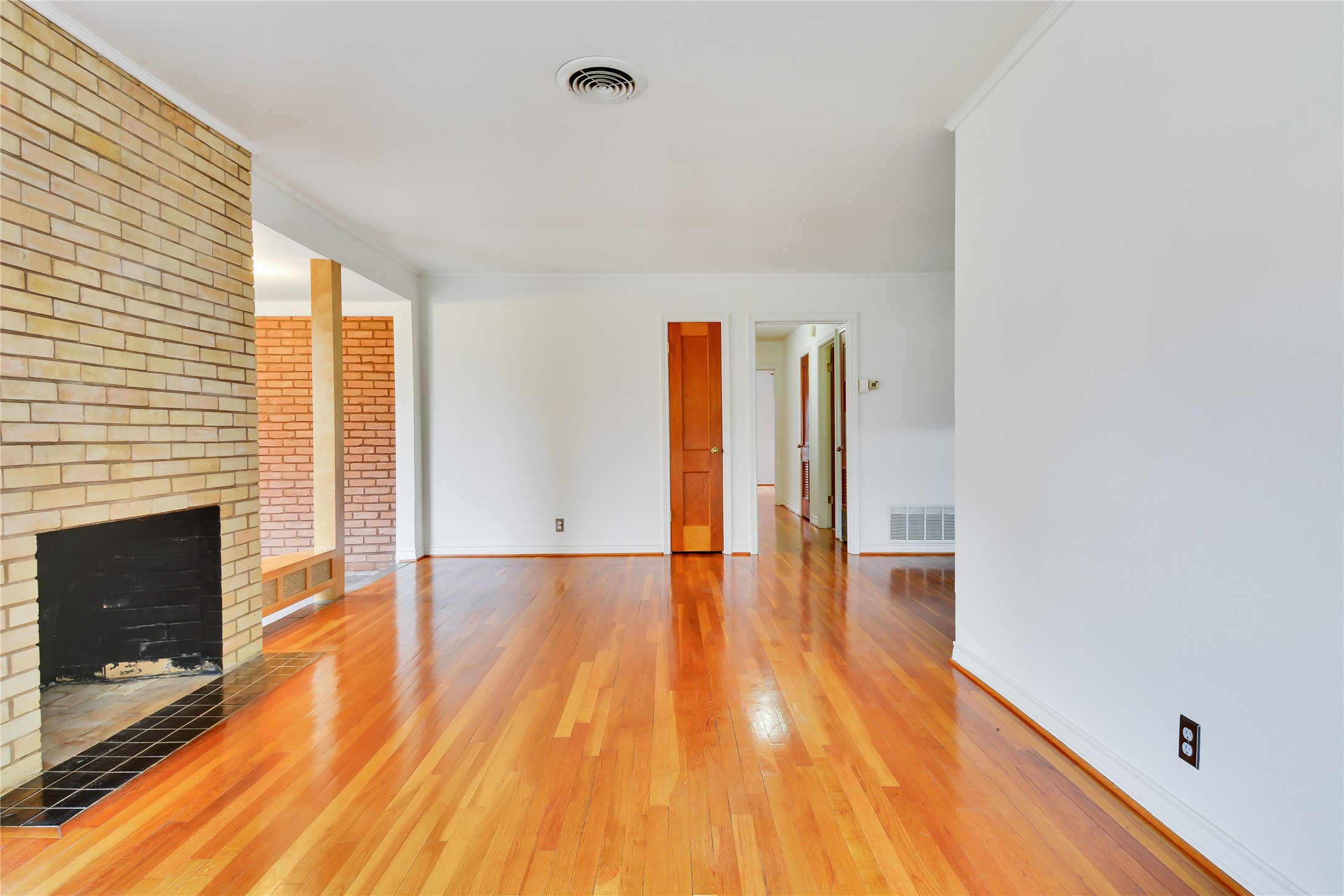 2300 Rebel Road Austin, TX 78704 - Photo 3 of 26 Living space with a brick fireplace, sleek hardwood floors, and an open atmosphere.