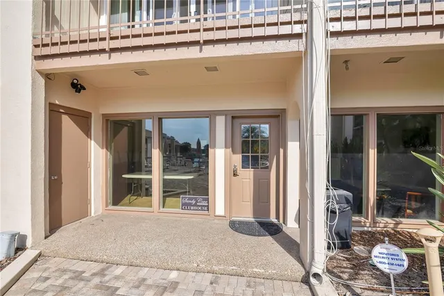 a living room with a rug and a large window