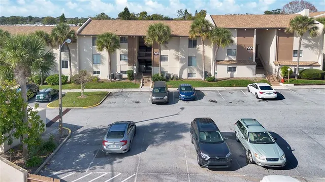 a view of a house with backyard sitting area and swimming pool