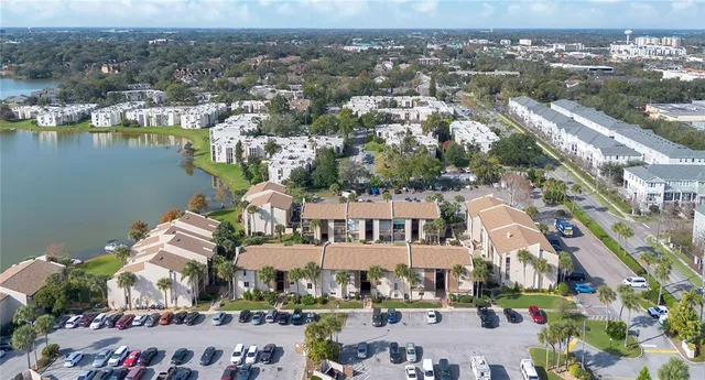 an aerial view of a city with a lake view