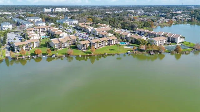 an aerial view of a houses with a lake view