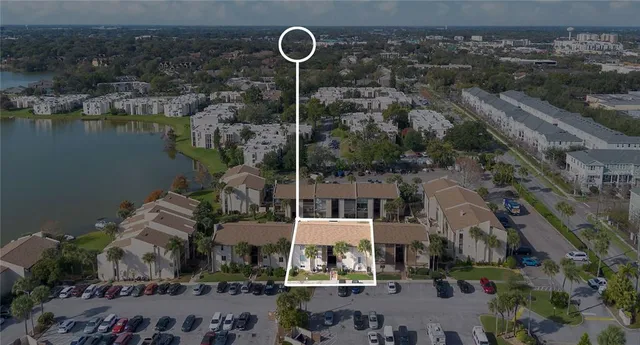 an aerial view of a house with a lake view