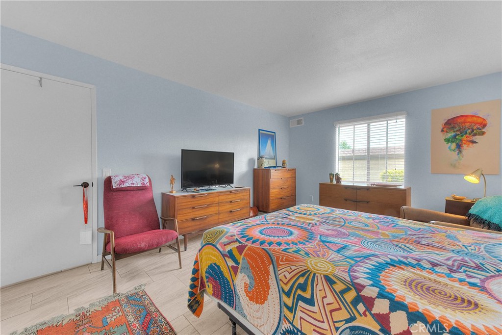 6351 Riverside Drive, Unit 69 Chino, CA 91710 - Photo 11 of 21 a bedroom with a bed and wooden floor