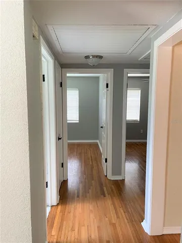 a view of hallway with wooden floor