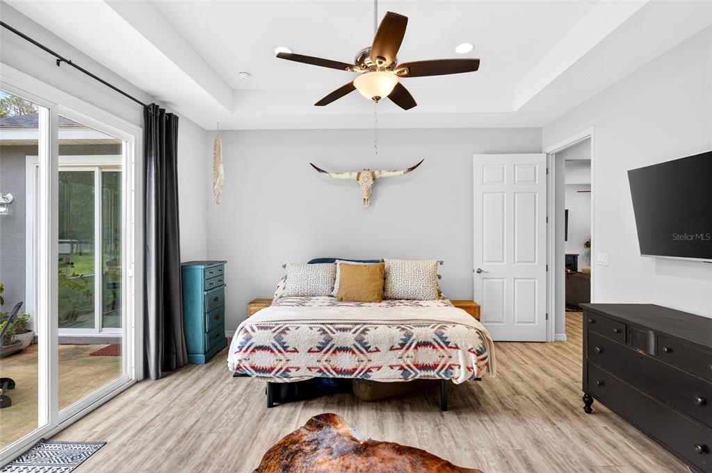 3699 Southwest 177th Lane Road Ocala, FL 34473 - Photo 11 of 26 a bedroom with a bed and a flat screen tv