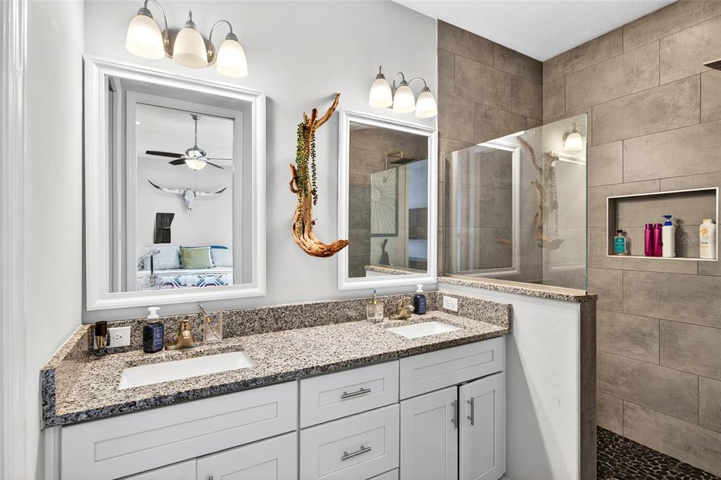3699 Southwest 177th Lane Road Ocala, FL 34473 - Photo 13 of 26 a bathroom with a granite countertop double vanity sink and a mirror
