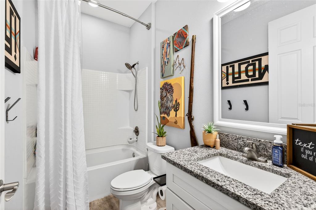 3699 Southwest 177th Lane Road Ocala, FL 34473 - Photo 17 of 26 a bathroom with a granite countertop tub sink mirror and shower