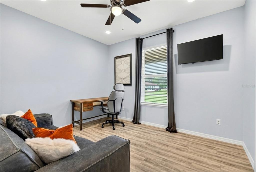 3699 Southwest 177th Lane Road Ocala, FL 34473 - Photo 18 of 26 a living room with furniture and a flat screen tv