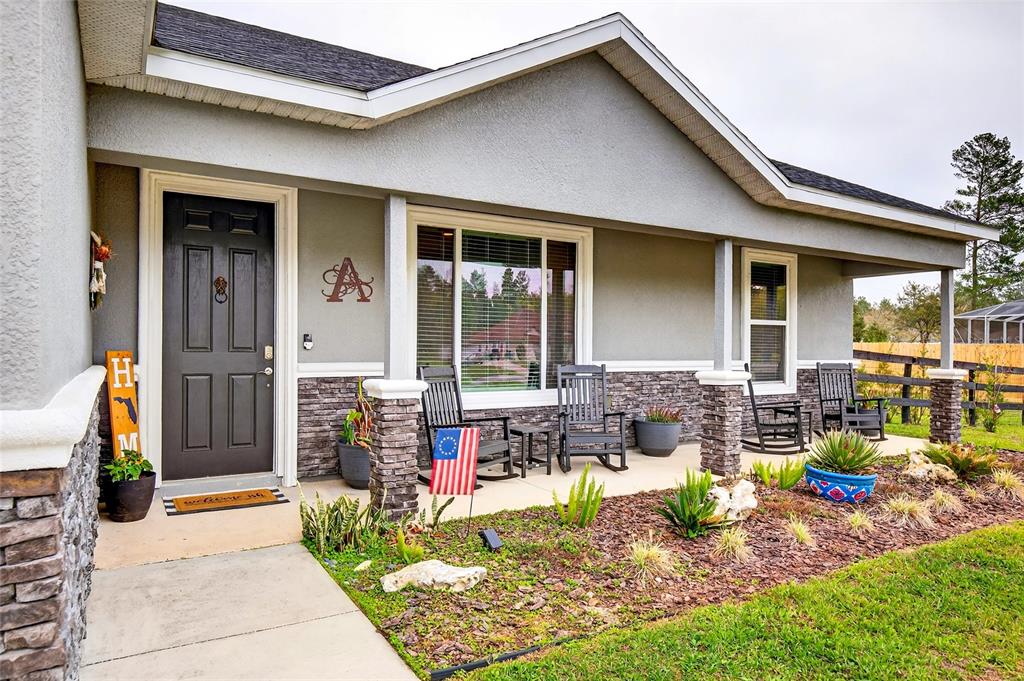3699 Southwest 177th Lane Road Ocala, FL 34473 - Photo 2 of 26 a front view of house with outdoor seating