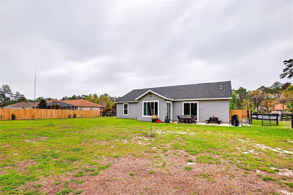 3699 Southwest 177th Lane Road Ocala, FL 34473 - Photo 22 of 26 a view of a house with a big yard and large trees