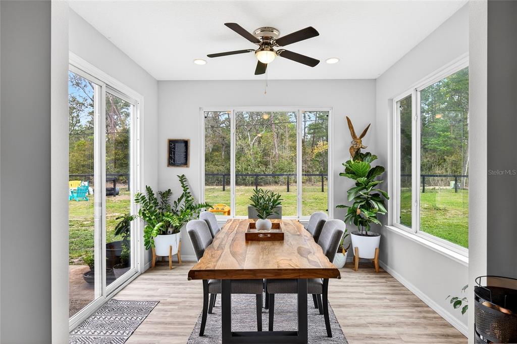 3699 Southwest 177th Lane Road Ocala, FL 34473 - Photo 4 of 26 a view of a dining room with furniture window and wooden floor