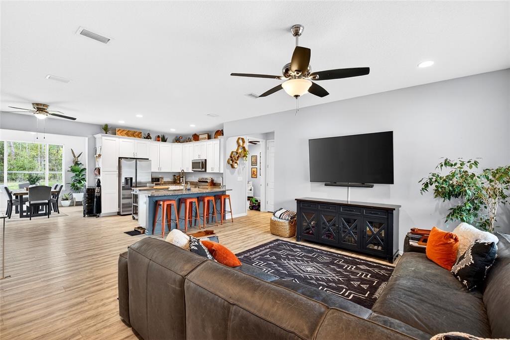 3699 Southwest 177th Lane Road Ocala, FL 34473 - Photo 6 of 26 a living room with furniture a flat screen tv and a fireplace