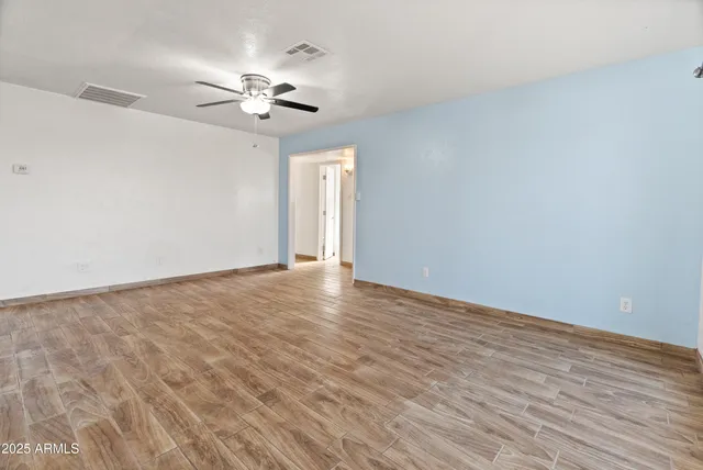 a view of a livingroom with a ceiling fan and window